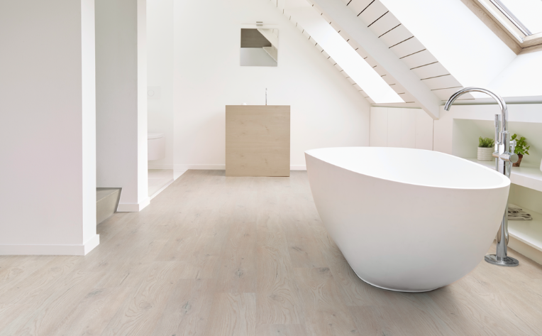 light wood look flooring in minimalist bathroom